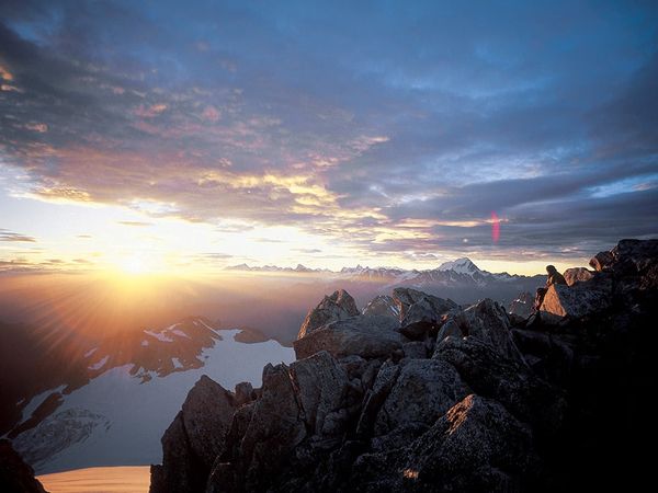 Sun, clouds and mountains